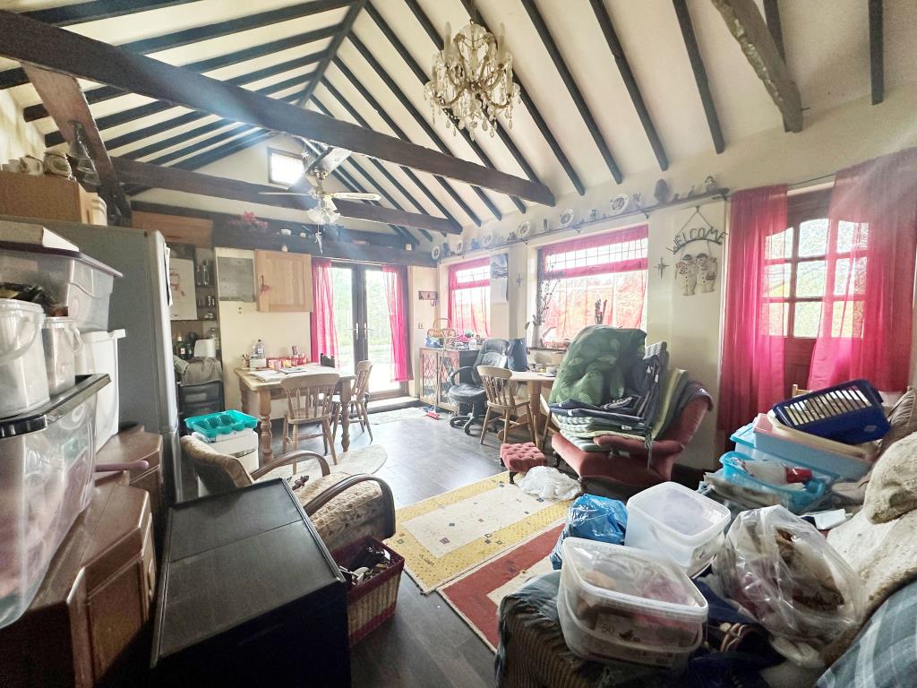 Lot: 174 - LAND WITH BUILDING, CARAVAN AND SWIMMING POOL IN RURAL LOCATION - Living room with vaulted ceilings and kitchen